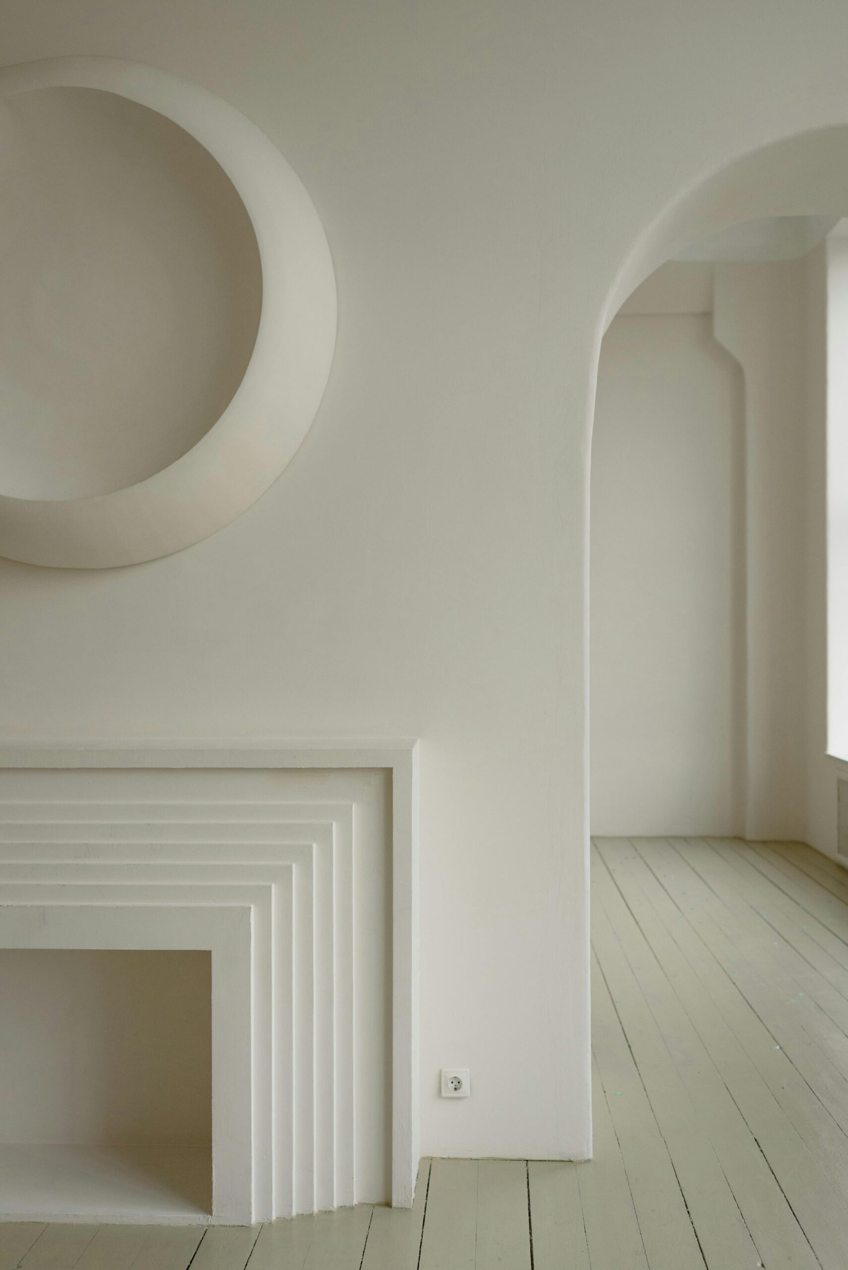 Modern minimalist room showcasing white geometric architectural details.